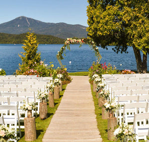 gold double hexagonal wedding arch at a lakefront venue