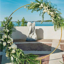 Load image into Gallery viewer, Modern Gold-Coated Round Wedding Arch on a brick patio overlooking an ocean view